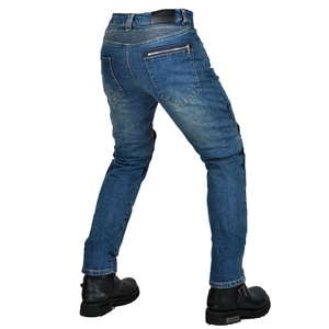 Detail view of motorcycle jeans with stretch accordion panels and heavy leather boots