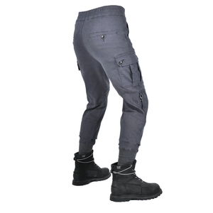 Detail view of motorcycle cargo pants featuring flap pockets and ribbed cuffs