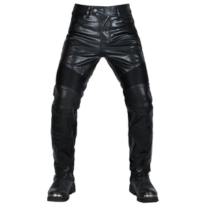 Detail view of motorcycle leather pants with elasticated knee panels and black biker boots