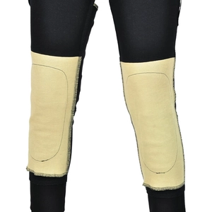 Detail view of khaki knee protection pads and stitching on black motorcycle riding pants