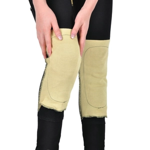 Detail of yellow protective knee pads with shock-absorbing foam for motorcycle riding pants