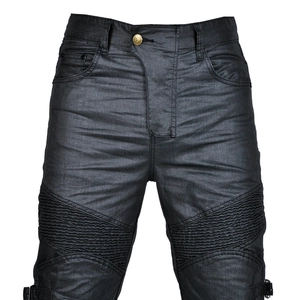 Detail view of black coated motorcycle jeans with accordion pleats on knees and metal button