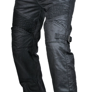 Detail of motorcycle jeans with accordion stretch panels and tactical side buckles