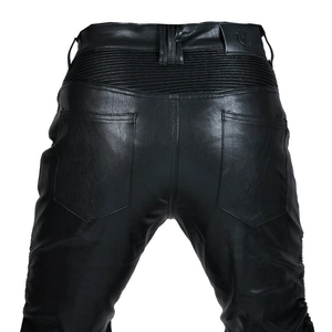 Close-up of the back waist with elastic stitching and logo patch on black motorcycle pants
