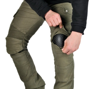 Detail of army green motorcycle pants showing protective knee pad and accordion stretch panels