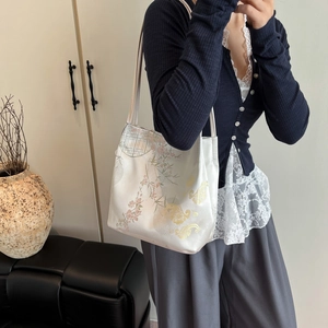 Elegant Chinese style tote bag with mountain and water embroidery in a minimalist room
