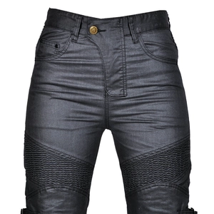 Close-up of dark grey coated biker jeans featuring ribbed panels and gold button detail