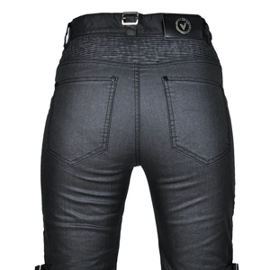 Detail of stretch accordion panels and black leather brand tag on vintage motorcycle jeans