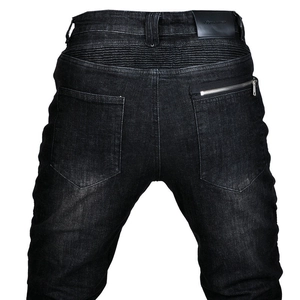 Macro detail of motorcycle jeans featuring elastic accordion panels and a zipper pocket