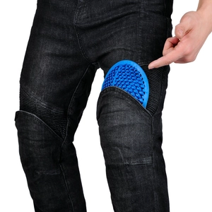 Detail of blue honeycomb armor pads being inserted into motorcycle jeans side pocket