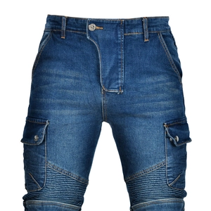 Detail of blue biker jeans with reinforced pleats and functional cargo pockets
