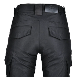 Close-up of back pockets and leather logo patch on black tactical motorcycle trousers