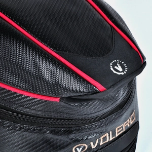 Close-up of VOLERO motorcycle tail bag showing premium carbon fiber texture and red piping