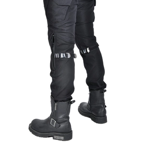 Detail showing motorcycle riding pants with adjustable knee straps and black biker boots