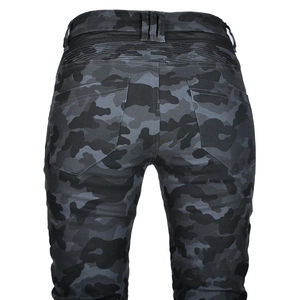 Detail of camouflage motorcycle pants featuring flexible accordion panels and zipper pockets