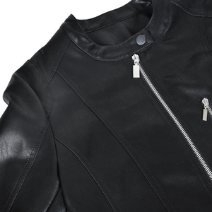 Close-up of black leather motorcycle jacket with silver zipper and metallic snap button