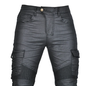 Detail of black coated denim motorcycle pants with accordion panels and cargo pockets