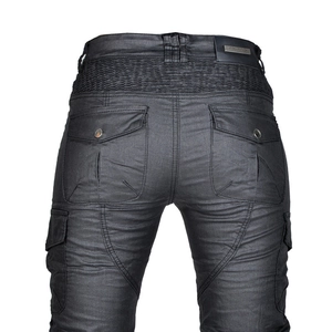 Macro view of motorcycle pants featuring accordion stretch panels and coated fabric texture