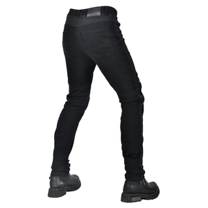 Detail view of motorcycle jeans with durable denim texture and back leather label
