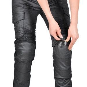 Detail of reinforced knee accordion panels and protective pad slots on black biker pants