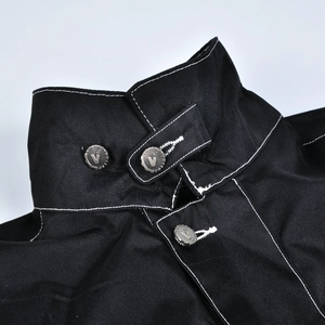 Détail macro du col d'une veste de moto avec coutures blanches et bouton métallique