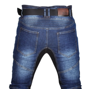 Macro detail of breathable motorcycle jeans with elastic panels and leather branding