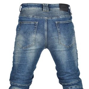 Detail view of motorcycle jeans featuring protective stretch panels and denim texture