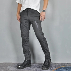 Detail of cargo pockets and reinforced stitching on dark grey motorcycle riding pants