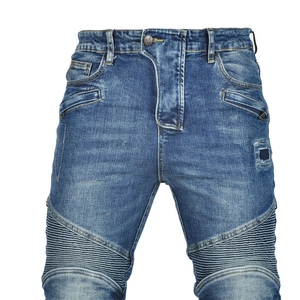 Macro detail of men's blue biker denim jeans with accordion stretch panels and stitching