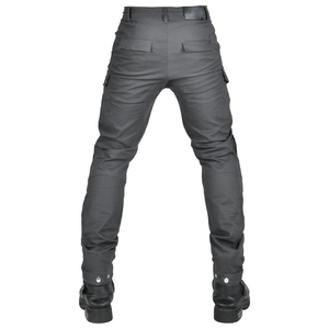Detail of gray motorcycle pants showing back pockets and adjustable snap cuffs with boots