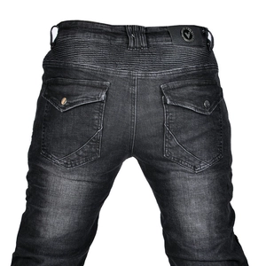 Detail of vintage motorcycle jeans showing reinforced accordion pleats and leather waist patch
