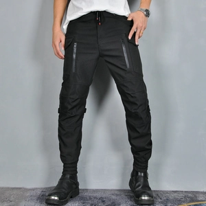 Detail of black motorcycle cargo pants with zipper pockets and reinforced knee panels