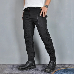 Men's black cargo motorcycle pants with tactical multi-zipper pockets and ribbed cuffs