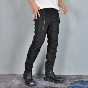 Detail of waterproof cargo motorcycle pants with functional pockets and reinforced knees
