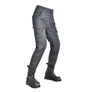 Detail of high-waisted motorcycle pants with utility pockets and heavy-duty biker boots