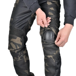 Close-up of removable knee armor and mesh panels on camo motorcycle riding pants
