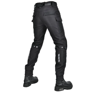 Detail view of motorcycle cargo pants featuring reflective safety strips and ankle cuffs