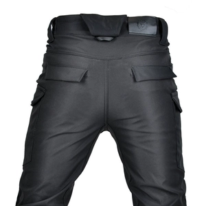 Rear view of waterproof motorcycle pants with large cargo pockets and leather logo patch