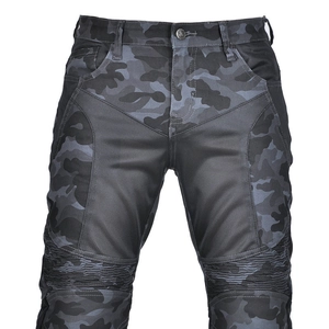 Close-up of camouflage motorcycle pants featuring breathable mesh panels and ribbed knee flex zones