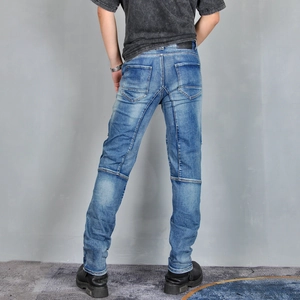 Detail view of men's blue motorcycle jeans showing reinforced stitching and slim cut