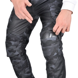 Detail showing the installation of knee armor protectors into camouflage motorcycle pants