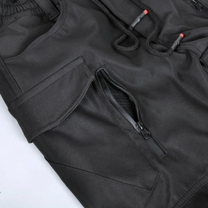 Detail of waterproof motorcycle pants with elastic high waist and breathable zipper mesh