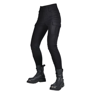 Detail of female biker cargo pants with side flap pockets and metal buckle motorcycle boots