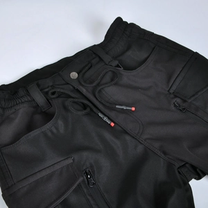 Detail of waterproof motorcycle pants with elastic drawstring waist and tactical pockets