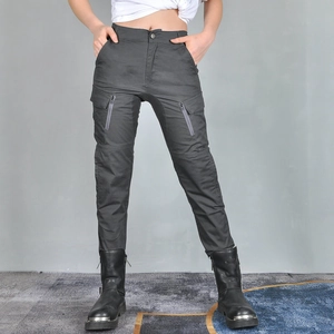 Detail of dark grey motorcycle pants featuring functional zip cargo pockets and knee stitching