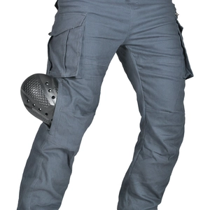 Detail showing silicone armor insert being placed into motorcycle cargo pants pocket