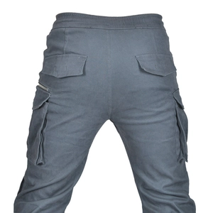 Close-up of motorcycle cargo pants featuring rear flap pockets and durable twill fabric