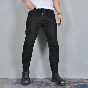 Detail of black motorcycle cargo pants with large flap pockets and drawstring waist design