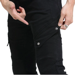 Detail of cargo pocket with dual silver metal snaps on black motorcycle riding pants