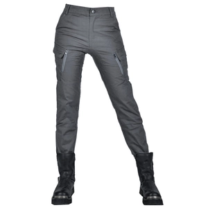 Detail of grey motorcycle cargo pants featuring side zipper pockets and metal-toe boots